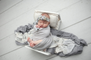 Newborn & Baby Photographer Columbus Ohio 28 Little girl in grey blankets with headband in white bassinet